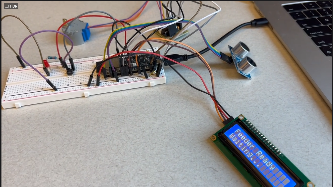 Embedded cat care prototype with sensors, display, and breadboard wiring.